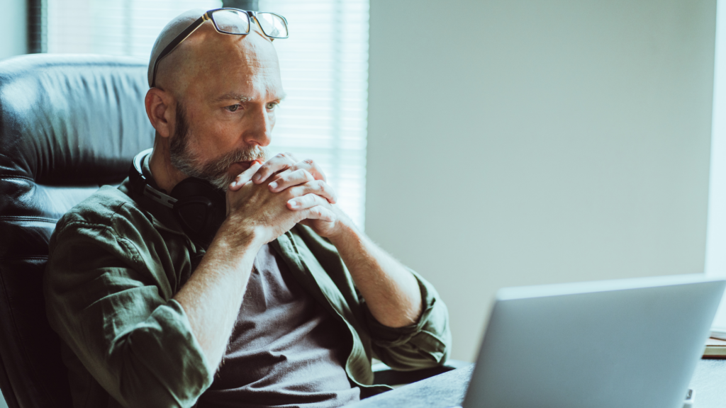 Man focusing his attention on a computer.