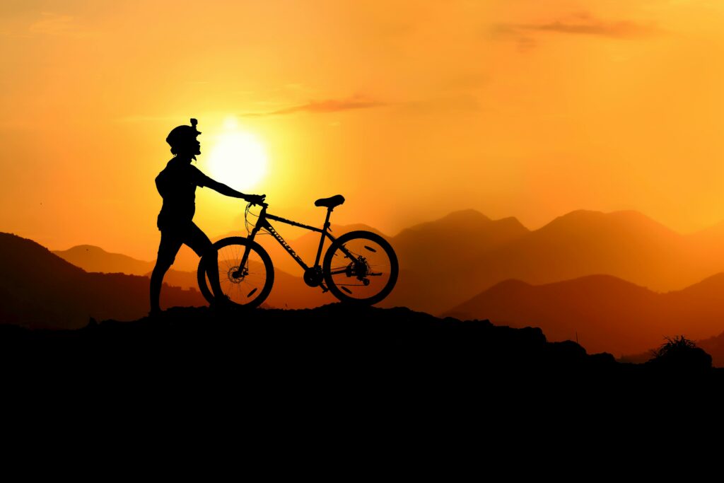Person cycling outdoors at sunrise